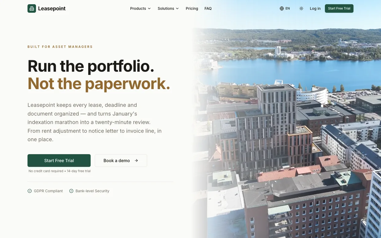 Leasepoint website hero: the headline “Run the portfolio. Not the paperwork.” beside an aerial photo of a waterfront city with modern commercial buildings.